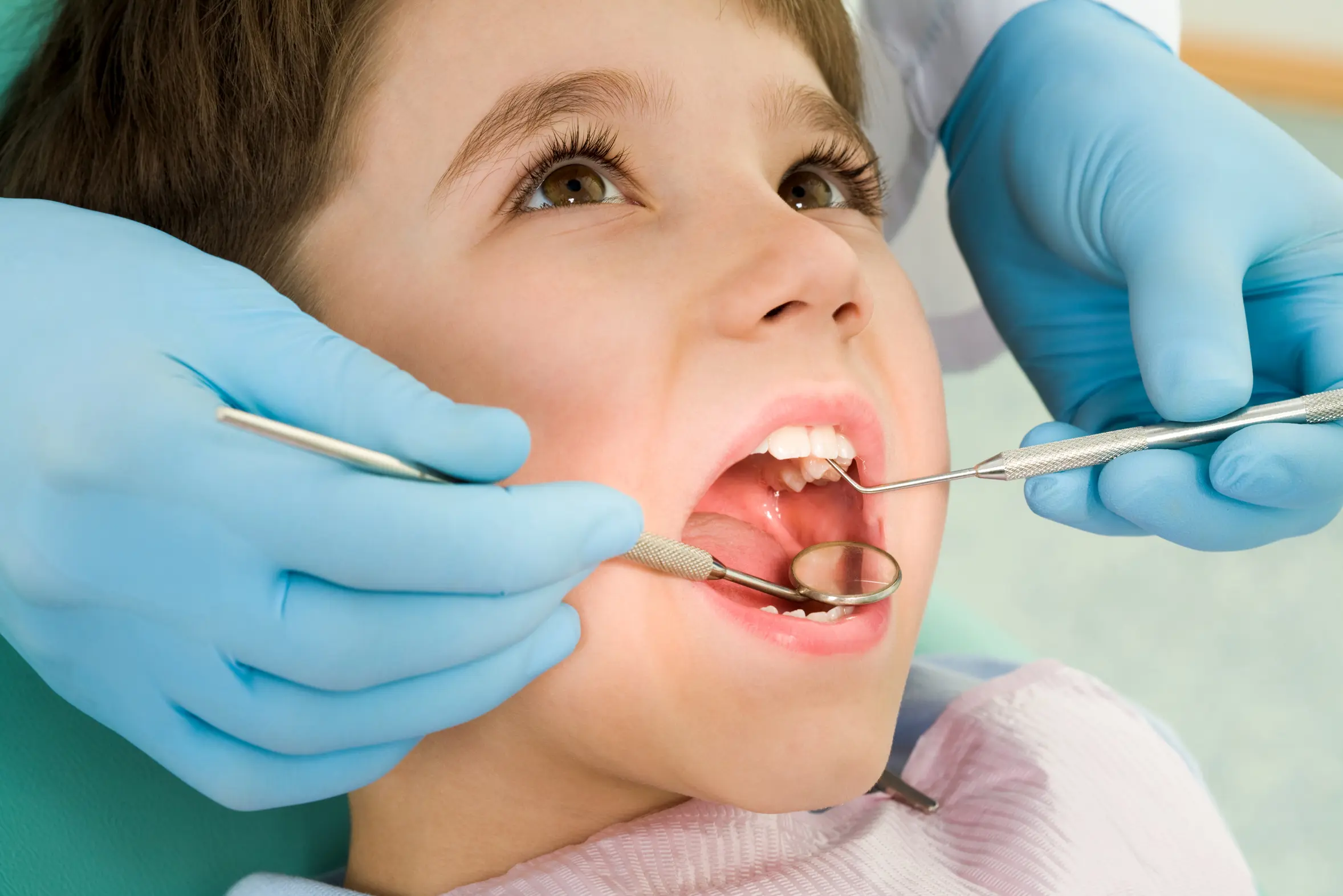 Child sitting in a dental chair during a friendly dental visit