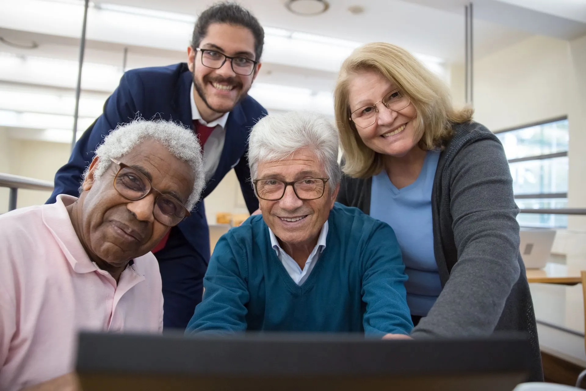Happy patients reviewing dental implant options with a dental professional