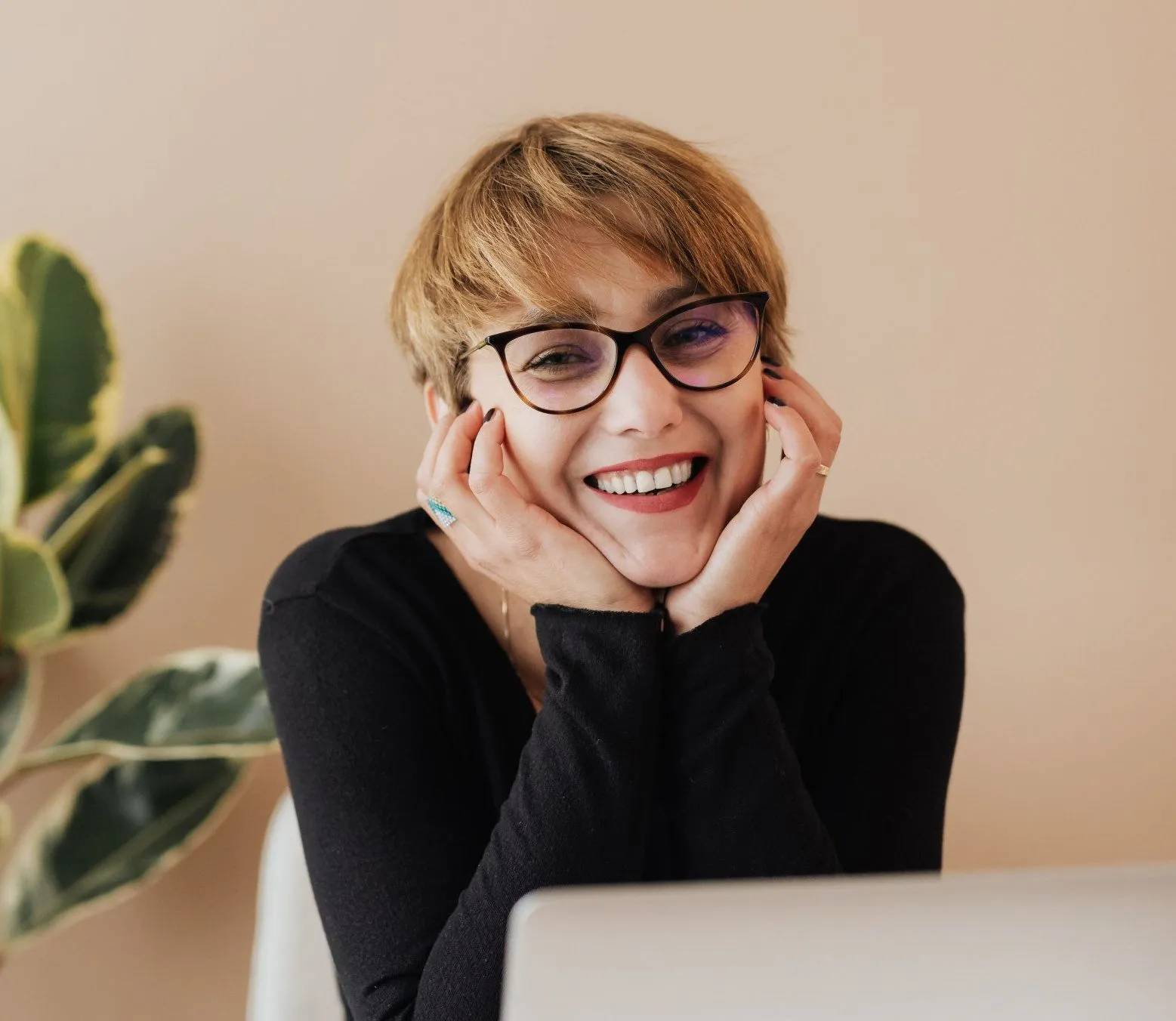 Woman smiling while reviewing financing options on a laptop